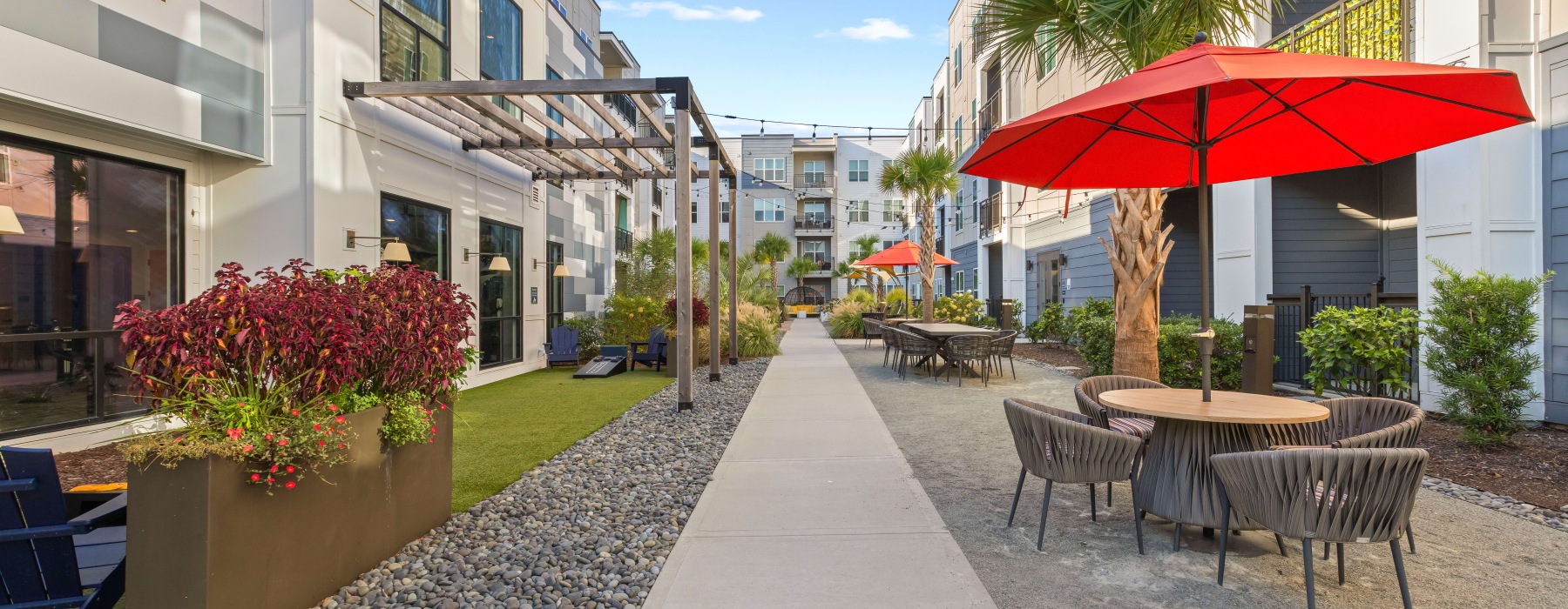 Sidewalk between two apartment buildings with a picnic table