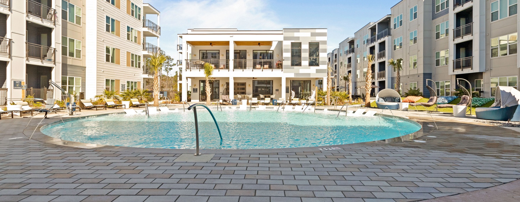 Pooldeck with beach chairs and courtyard